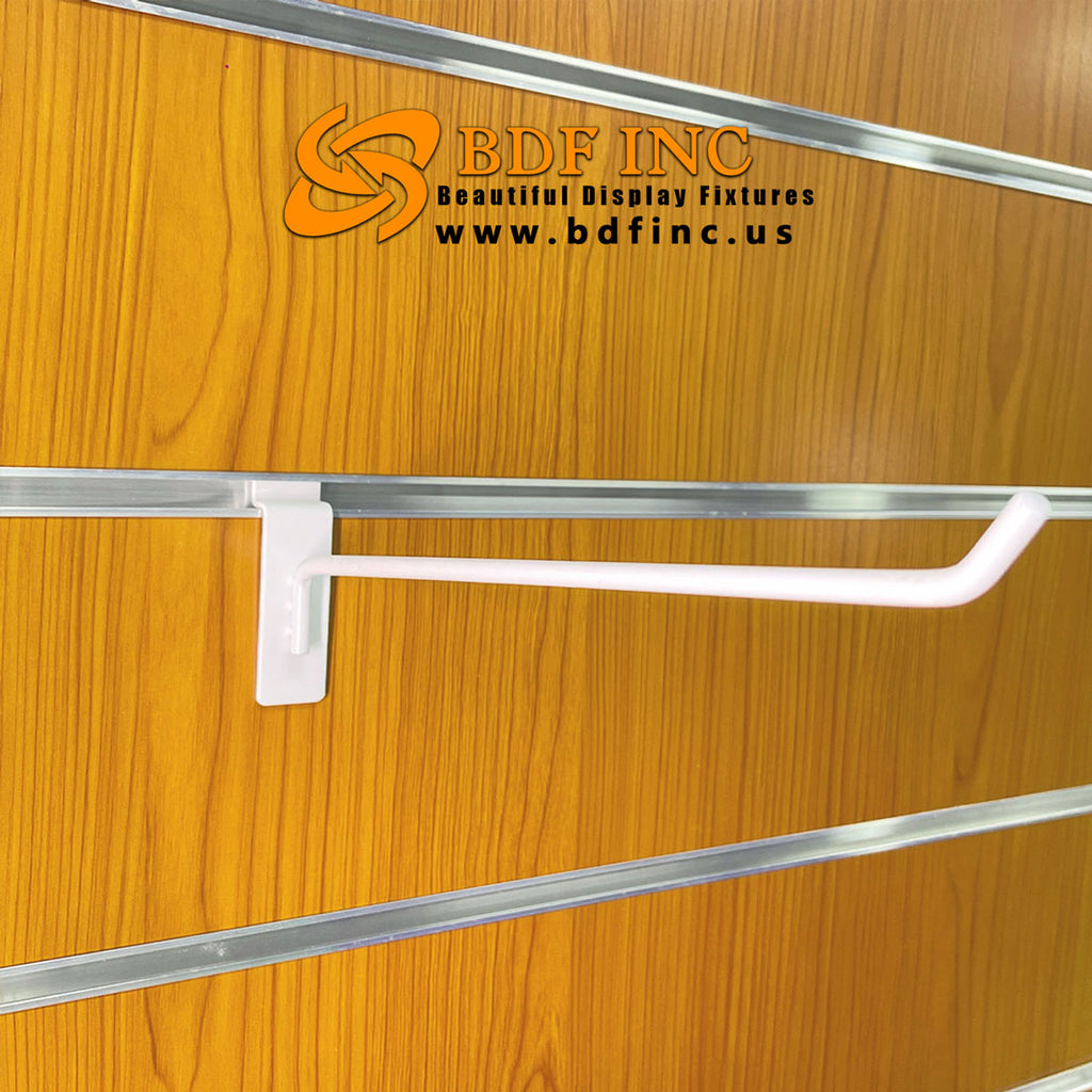 10 inch white slatwall hook displaying oversized retail items in bright setting