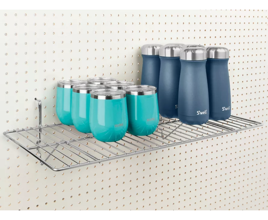 Professional chrome wire shelf mounted on a pegboard, ideal for displaying tools or merchandise in a hardware or beauty supply setting.
