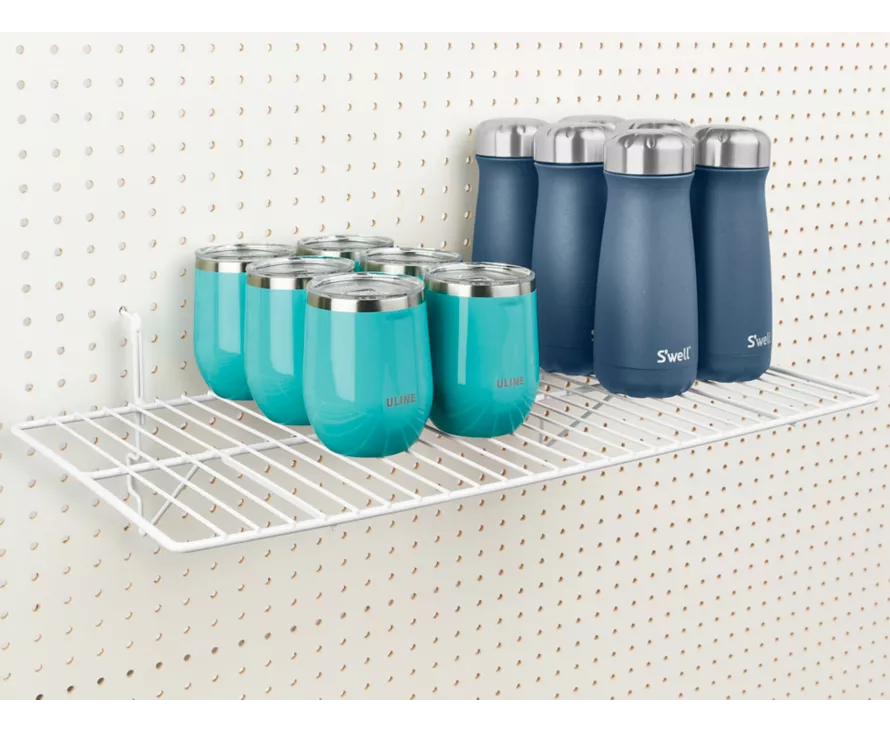 Large white wire shelf mounted on white pegboard, perfect for organizing household items or retail products.
