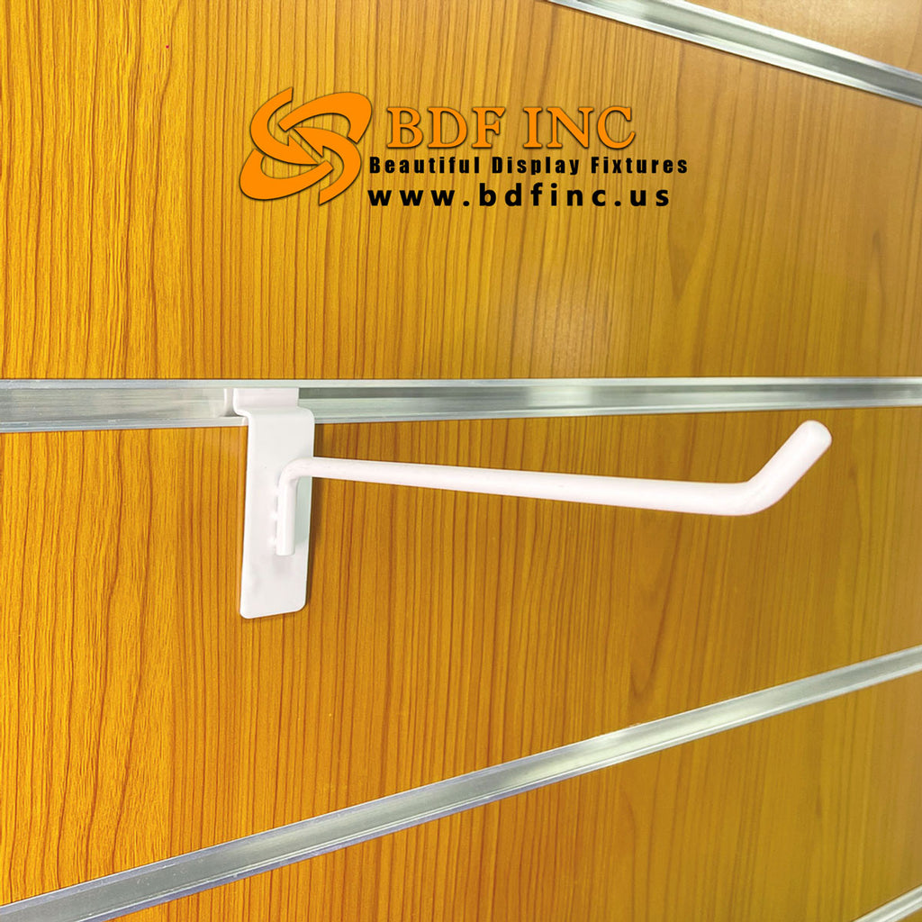 White 6 inch slatwall hook installed on slatwall panel displaying retail products