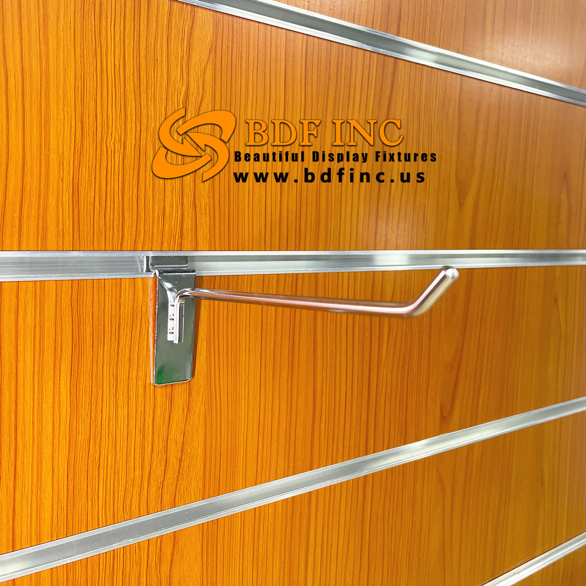 8 inch chrome slatwall hook displaying premium retail products in boutique setting