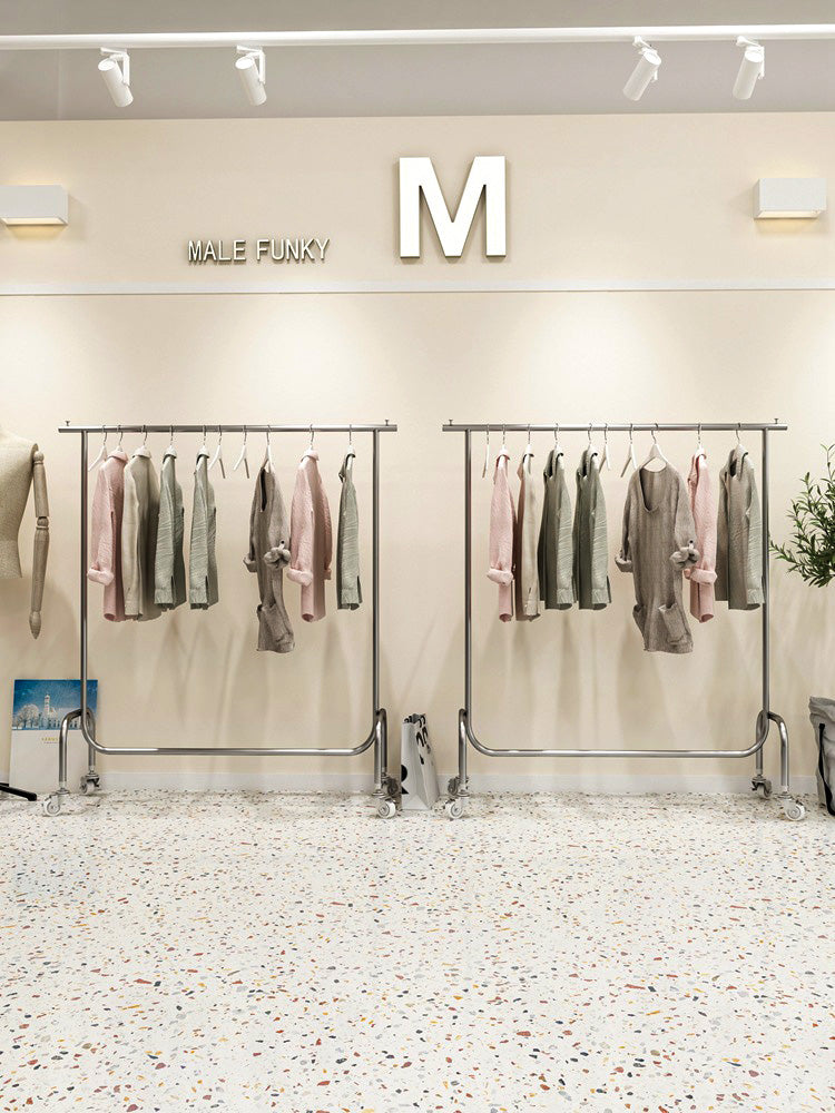 Heavy duty single bar clothing rack in warehouse environment, industrial strength for bulk storage