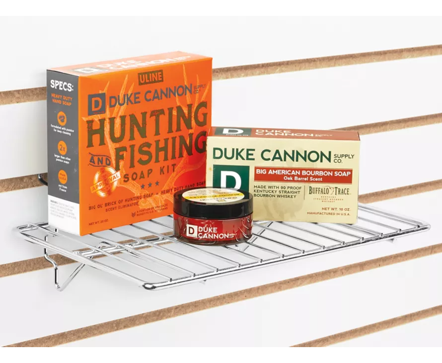 Sleek chrome wire shelf installed on a slatwall panel, creating a modern and professional display for retail goods.