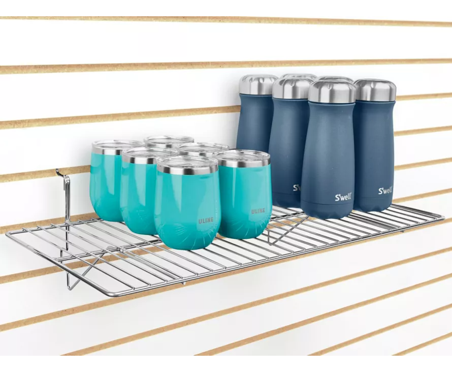 Spacious 12x24 inch chrome shelf installed on slatwall, creating a professional display for shoe collections or high-end accessories.