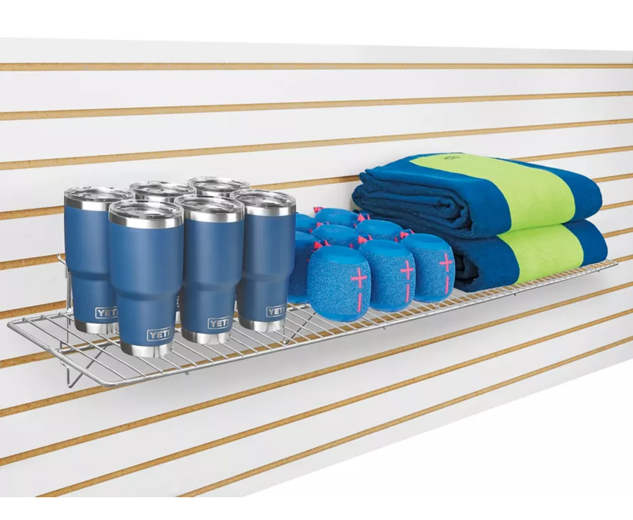 Extra-wide 12x48 inch chrome slatwall wire shelf installed on slatwall, creating a professional display for high-end merchandise.