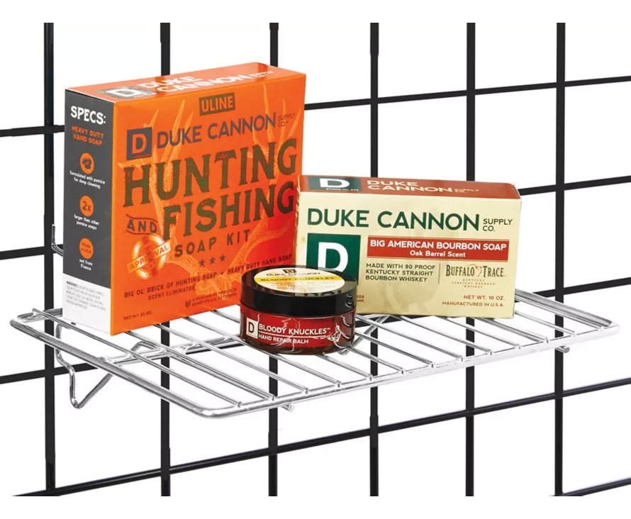 Professional chrome wire shelf installed on gridwall, providing a bright and reflective display for accessories.