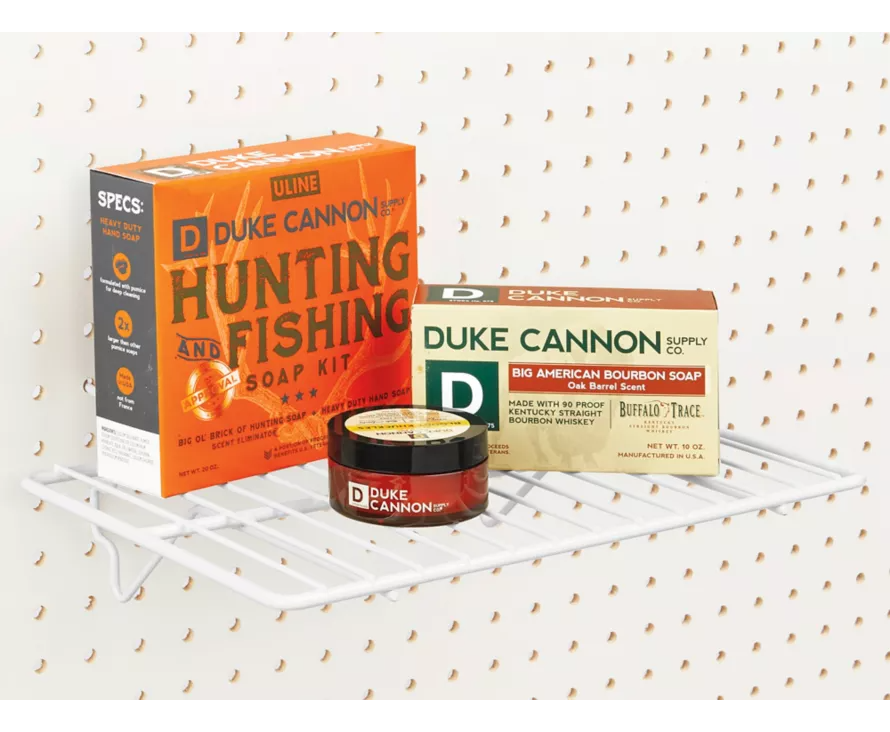 The versatile white wire shelf mounted on a white pegboard, ideal for organizing and displaying items in a bright retail or workshop space.