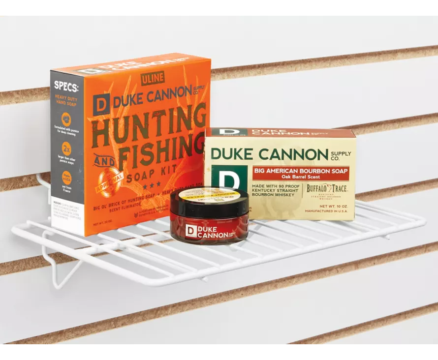 Bright white wire shelf installed on a white slatwall panel, creating a clean and modern display for retail merchandise.